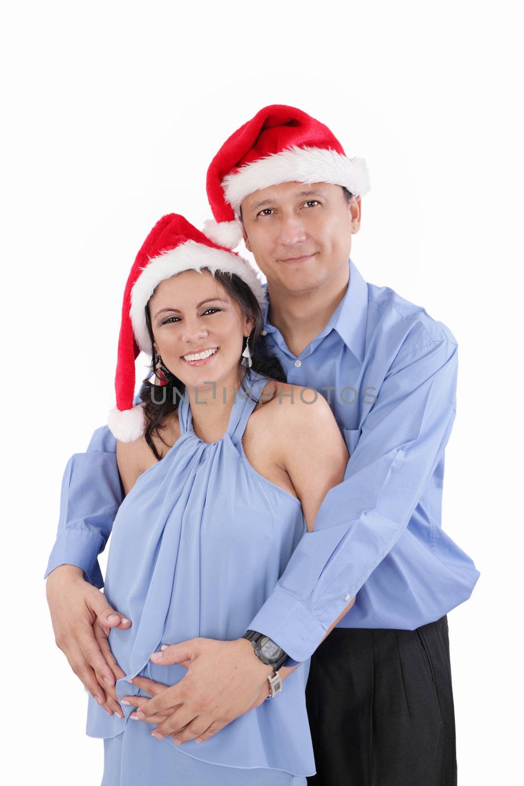 A beautiful young hispanic couple wearing Christmas Santa Hats