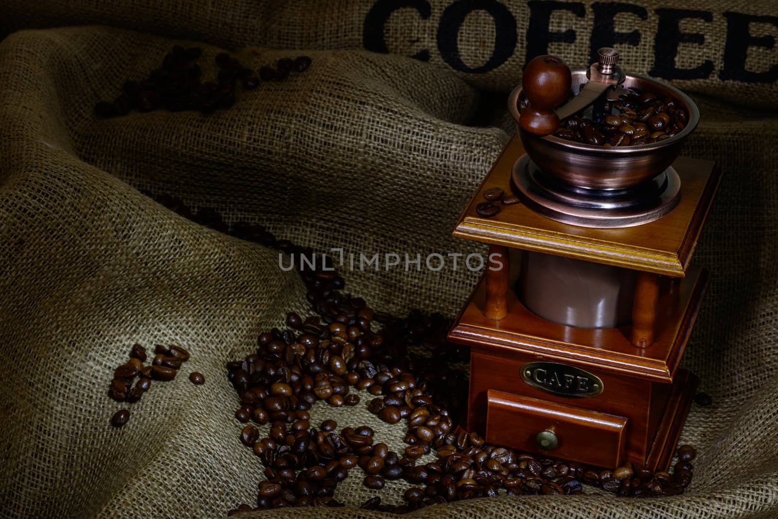 Coffee Mill with beans and burlap. still life