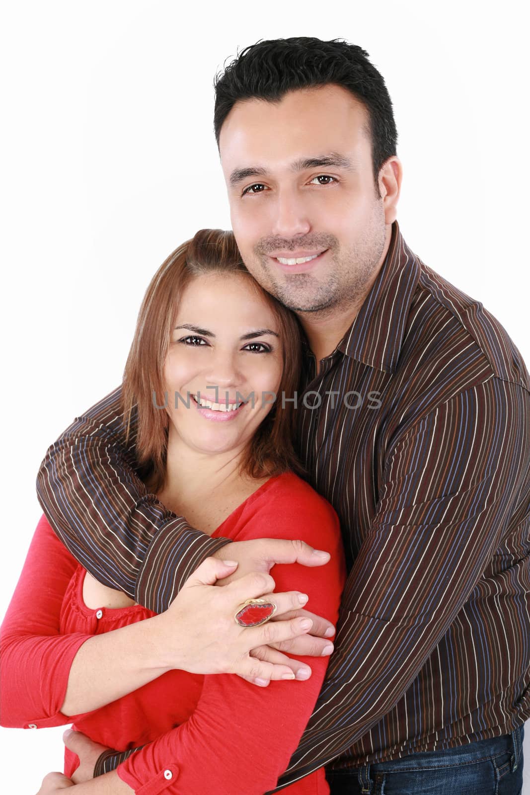 Portrait of a handsome man with his arms around his beautiful wife