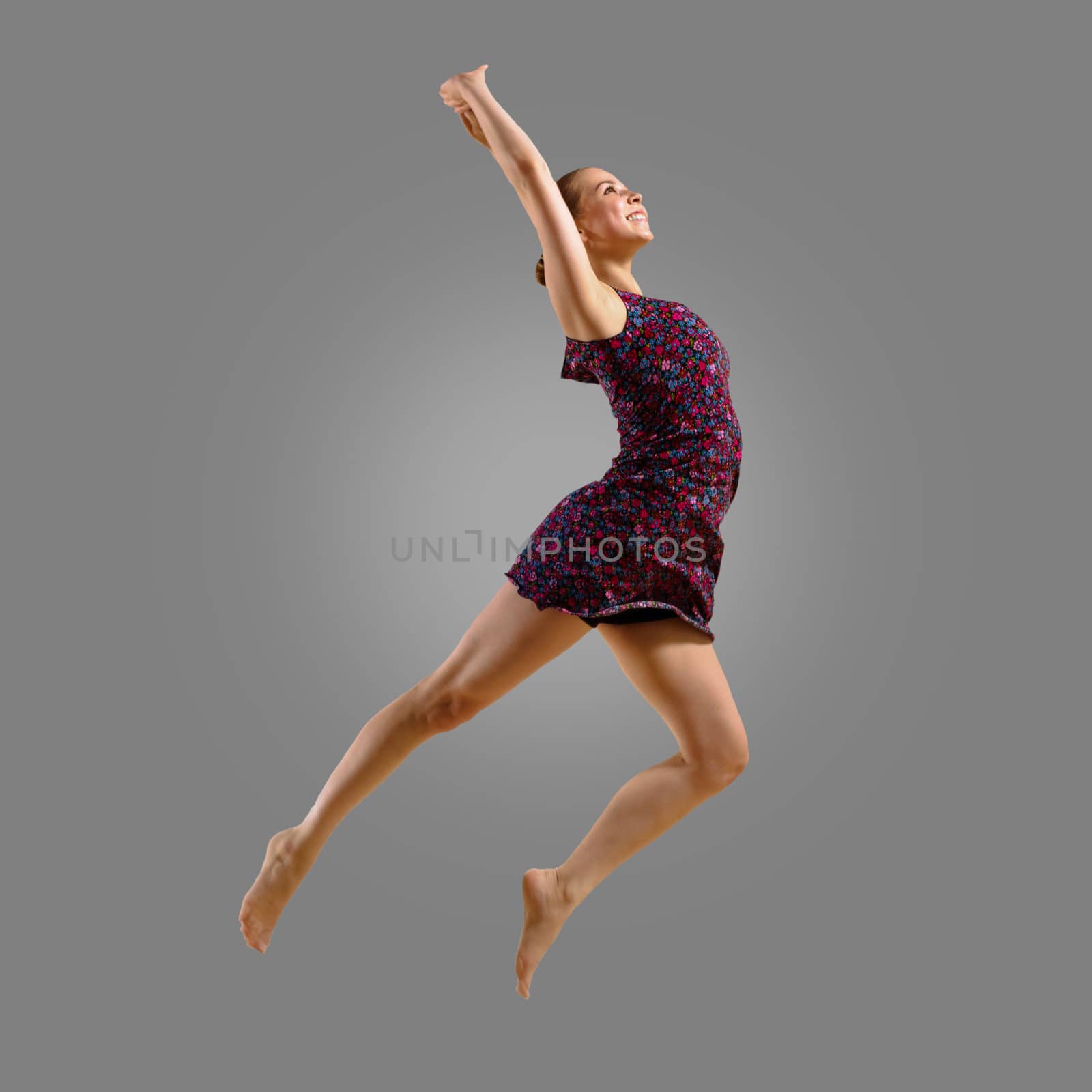 dancer jumping on a gray background, having a fun