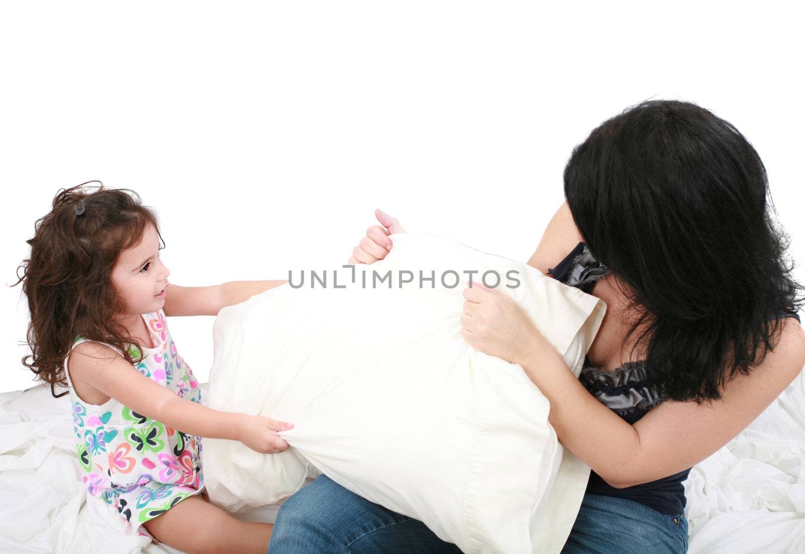 mother and daughter having fun with pillows by dacasdo