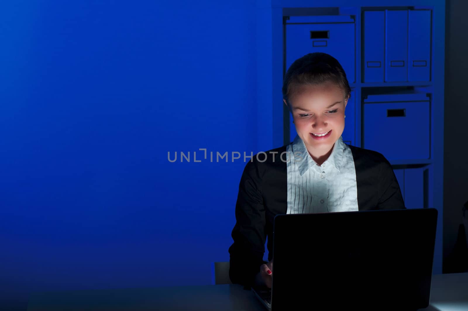 portrait of a woman in a night office, working all night