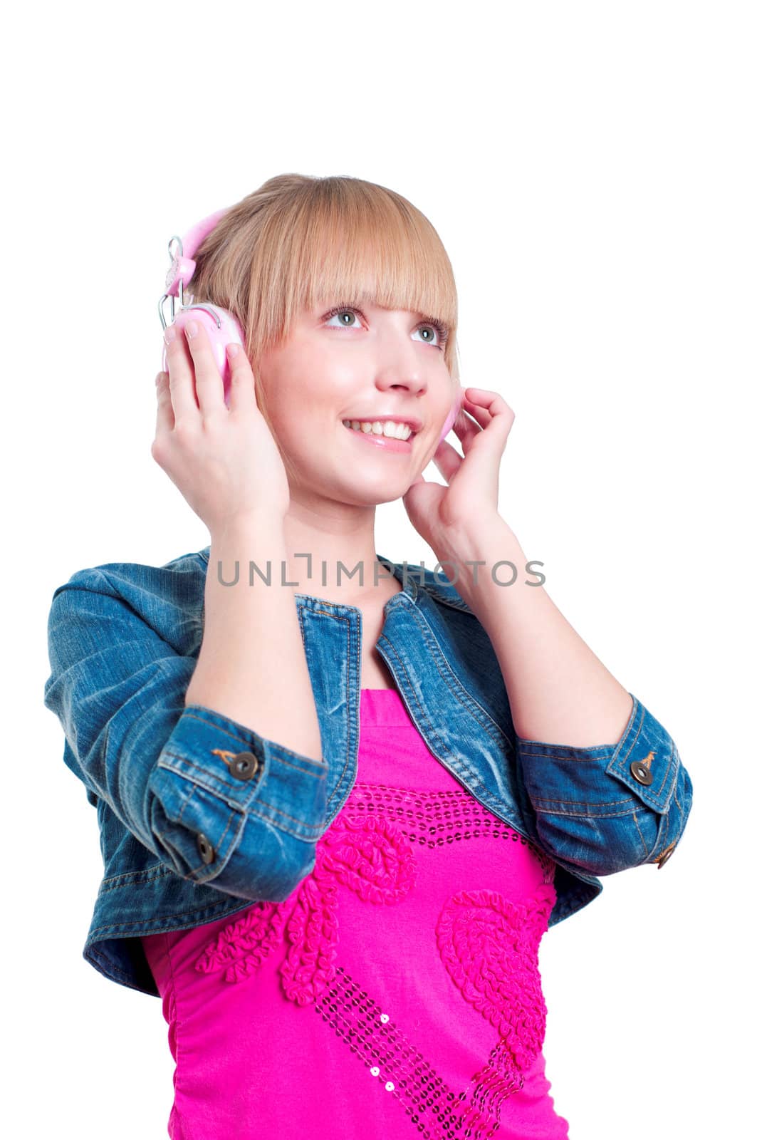 Young attractive woman listing to music with headphones against white background