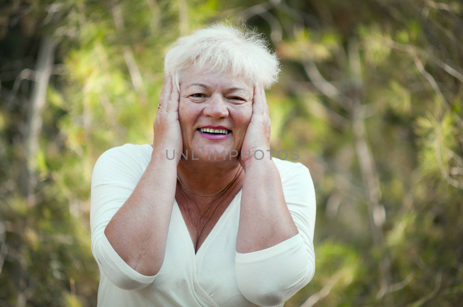 Elderly woman in a summer park .