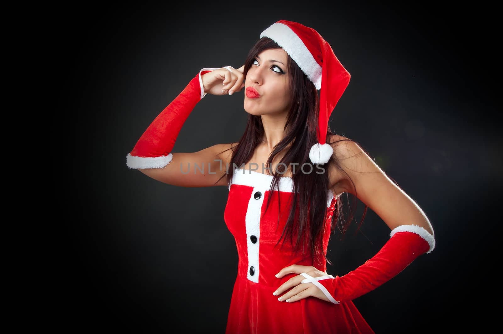 Portrait of beautiful sexy girl wearing santa claus clothes thinking