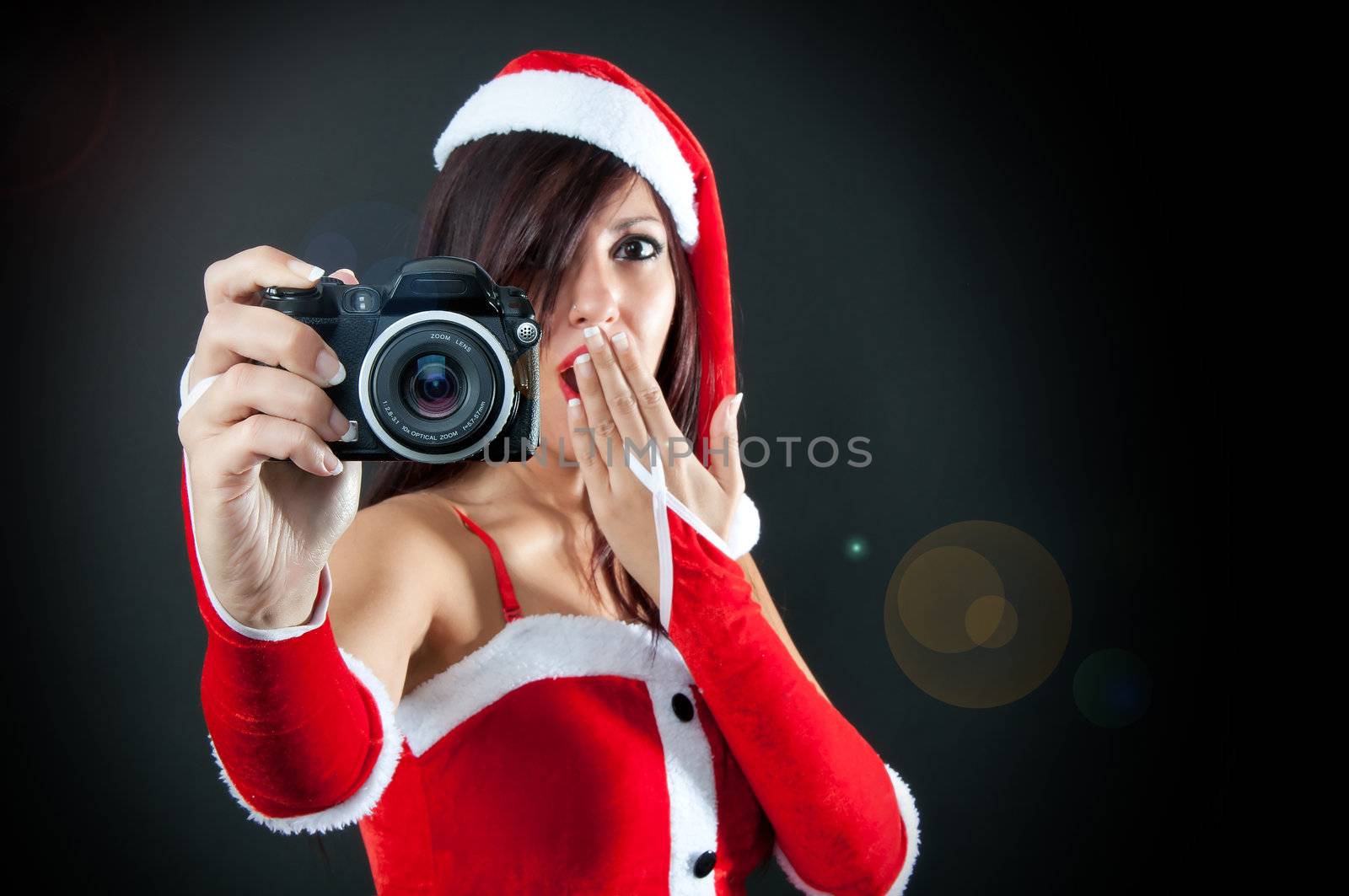 Portrait of Santa Claus surprised girl with Camera