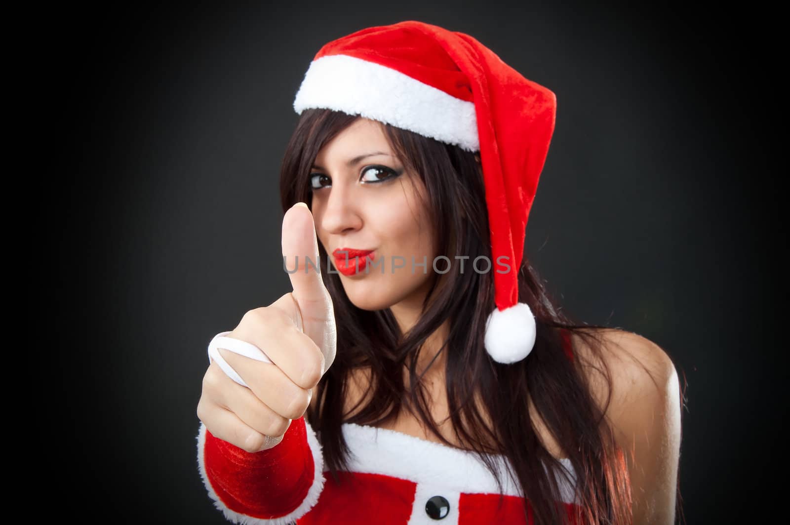 portrait girl wearing santa claus clothes giving an ok sign