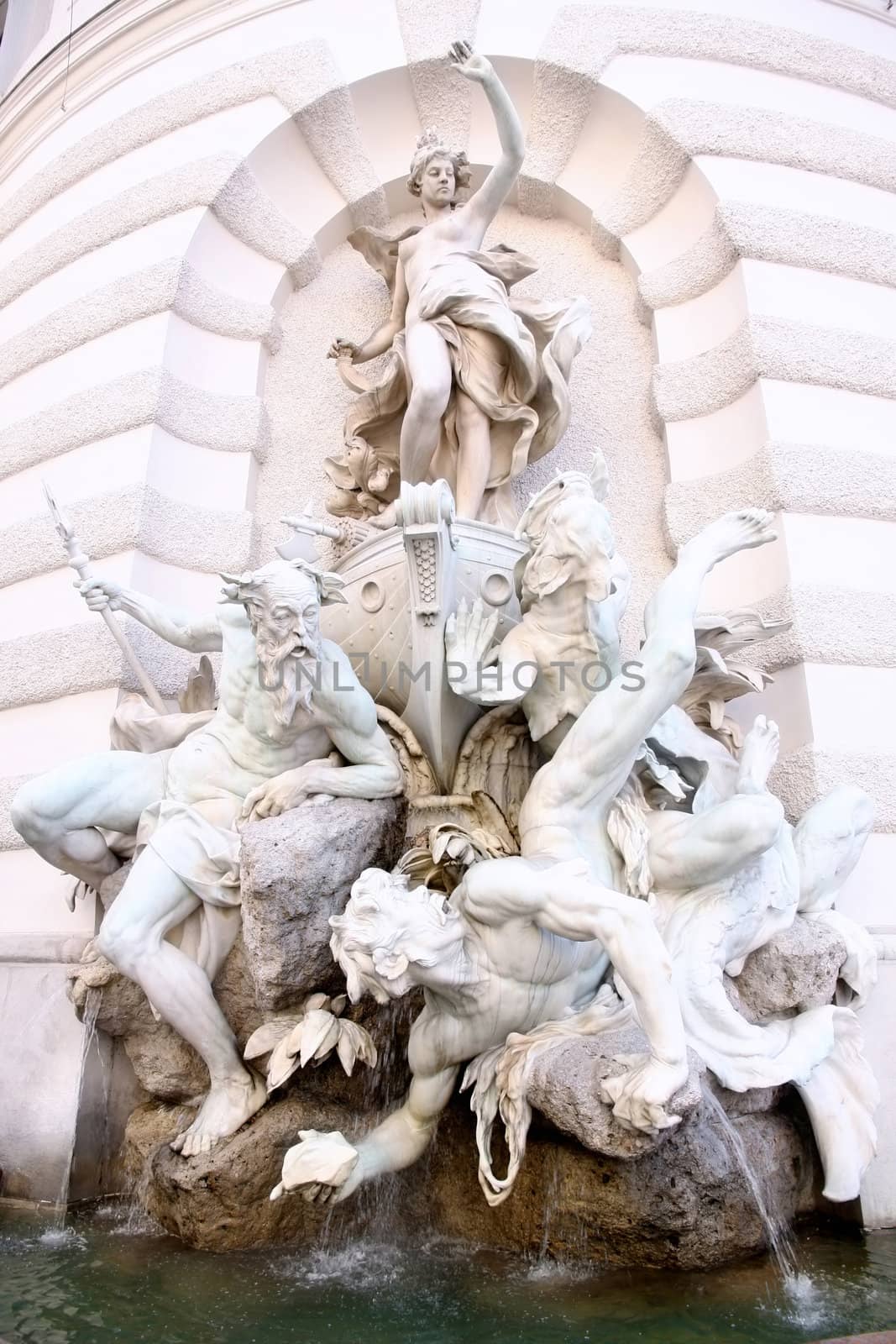 Sculptures on Michaelerplatz Fountain in Hofburg Quarter, Vienna, Austria 