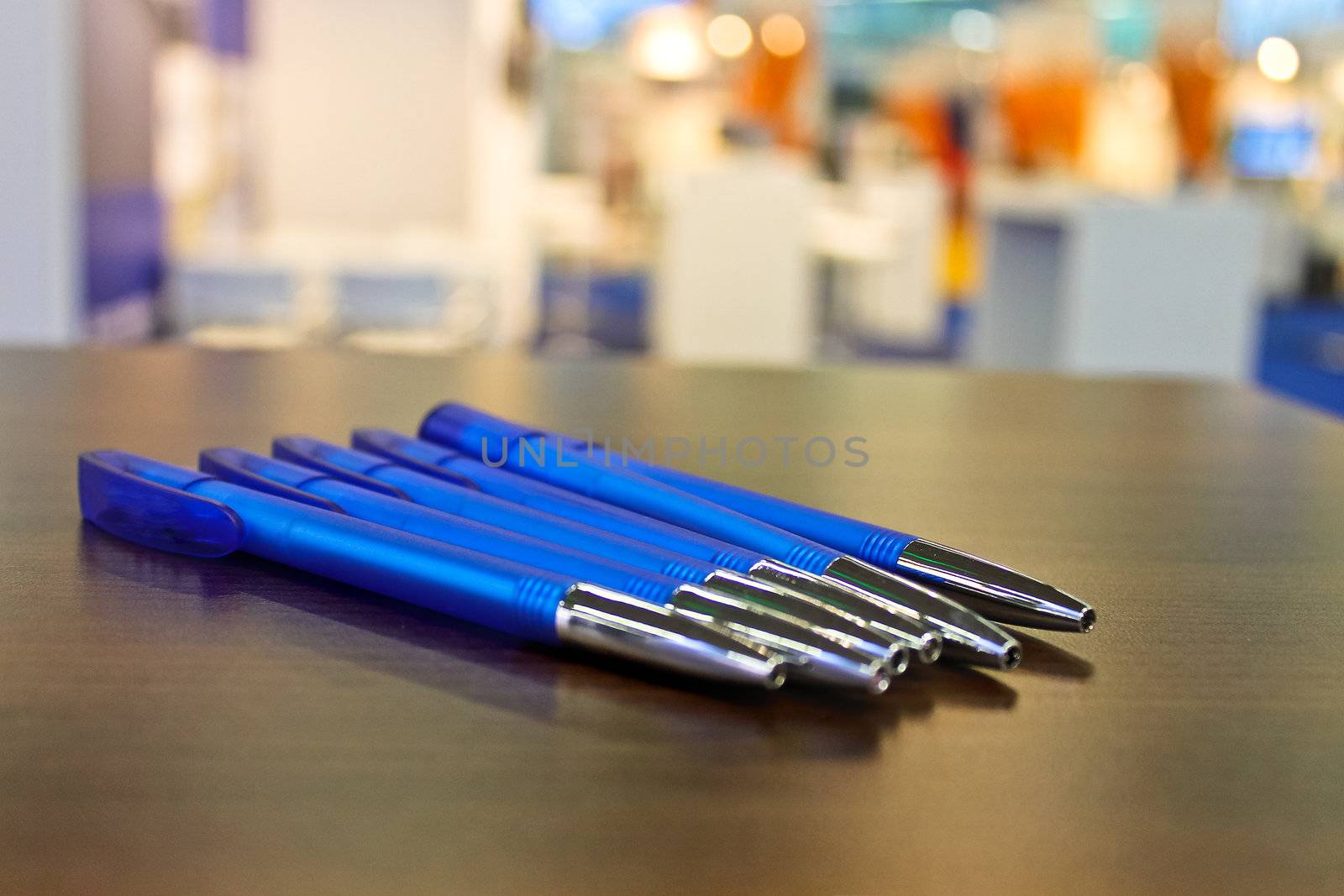 Several pens on the table at the exhibition by NickNick
