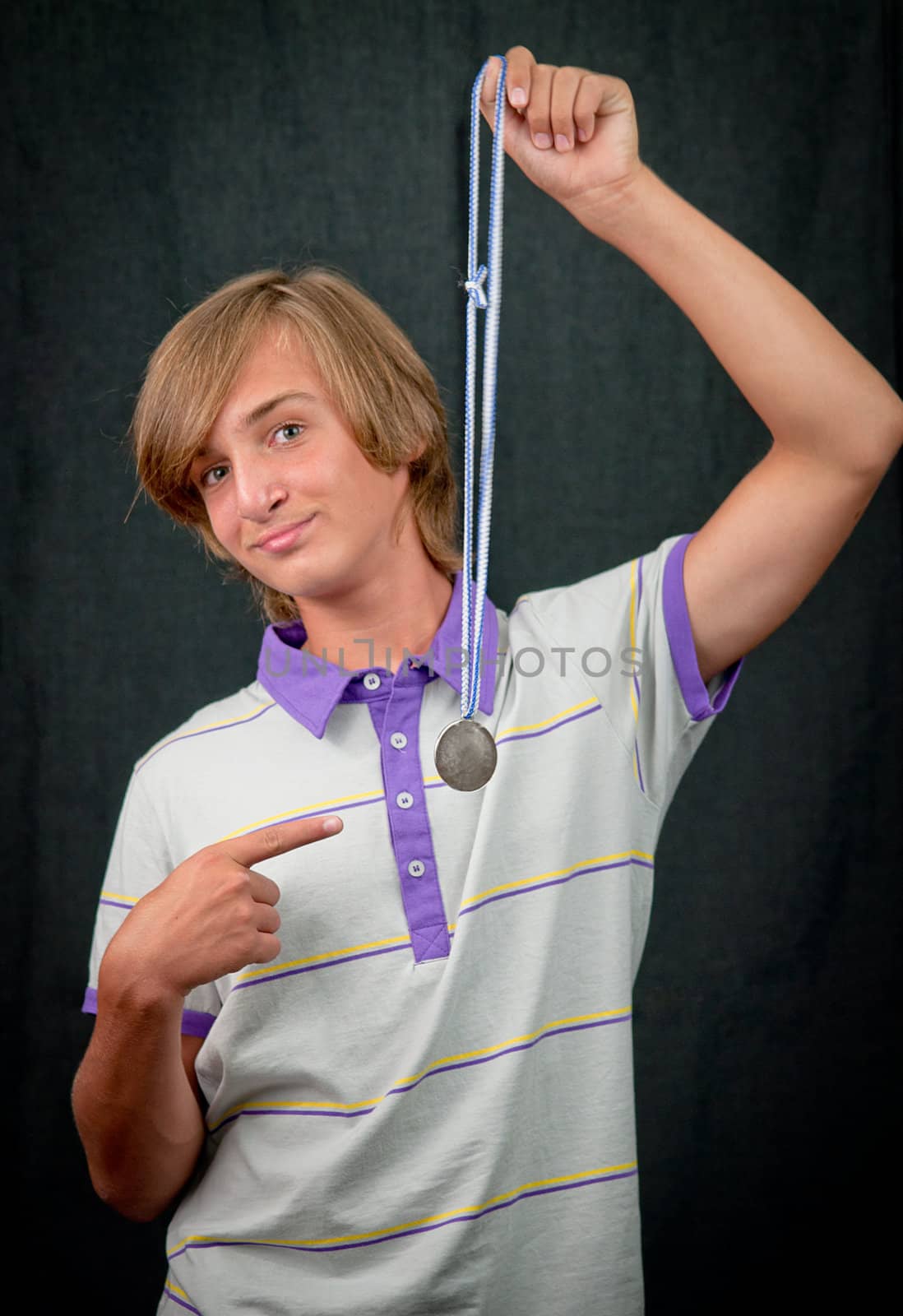 Studio closeup portrait of a  boy   with a medal . by LarisaP