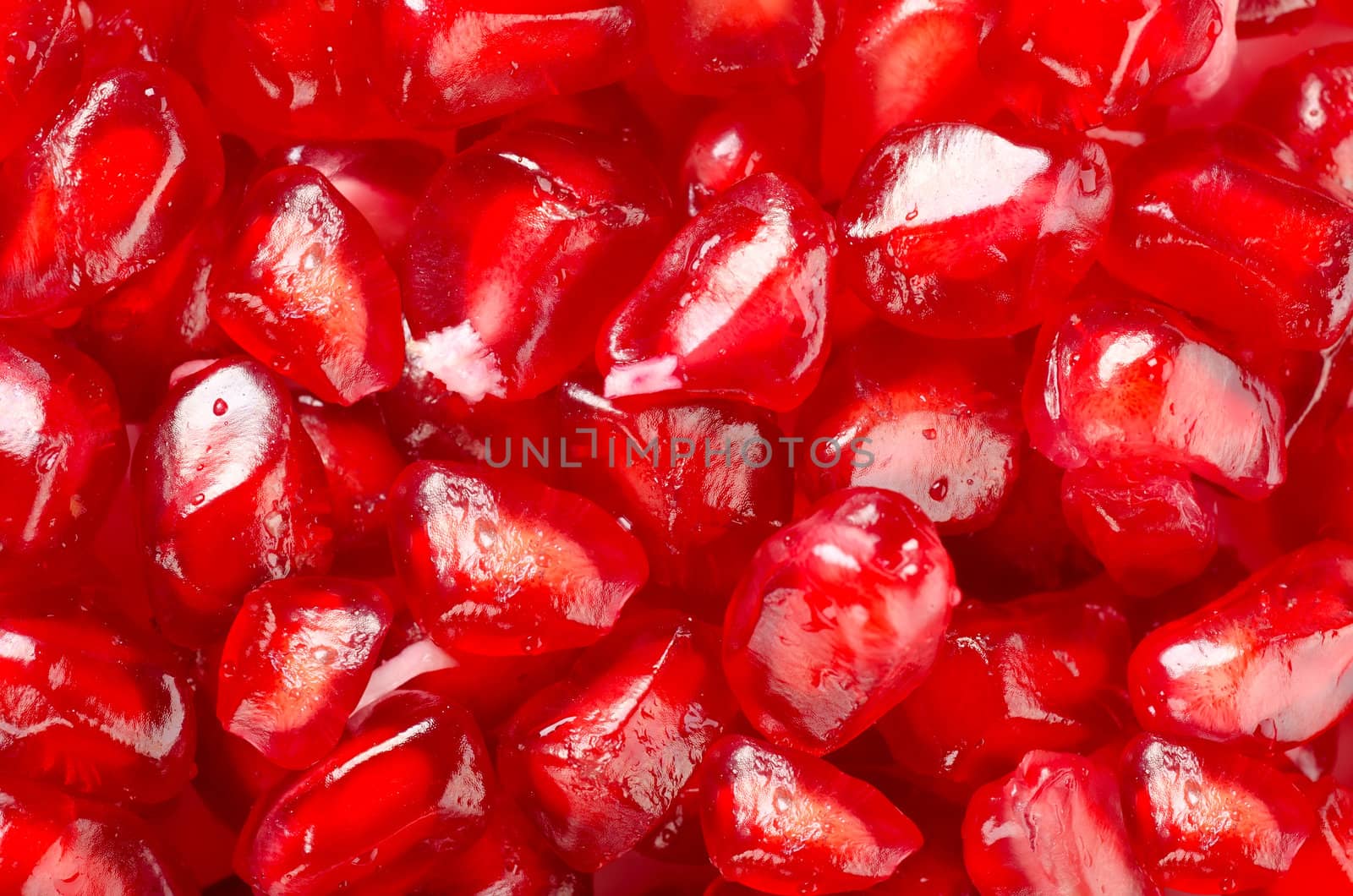 Ripe pomegranate seeds arranged as a background