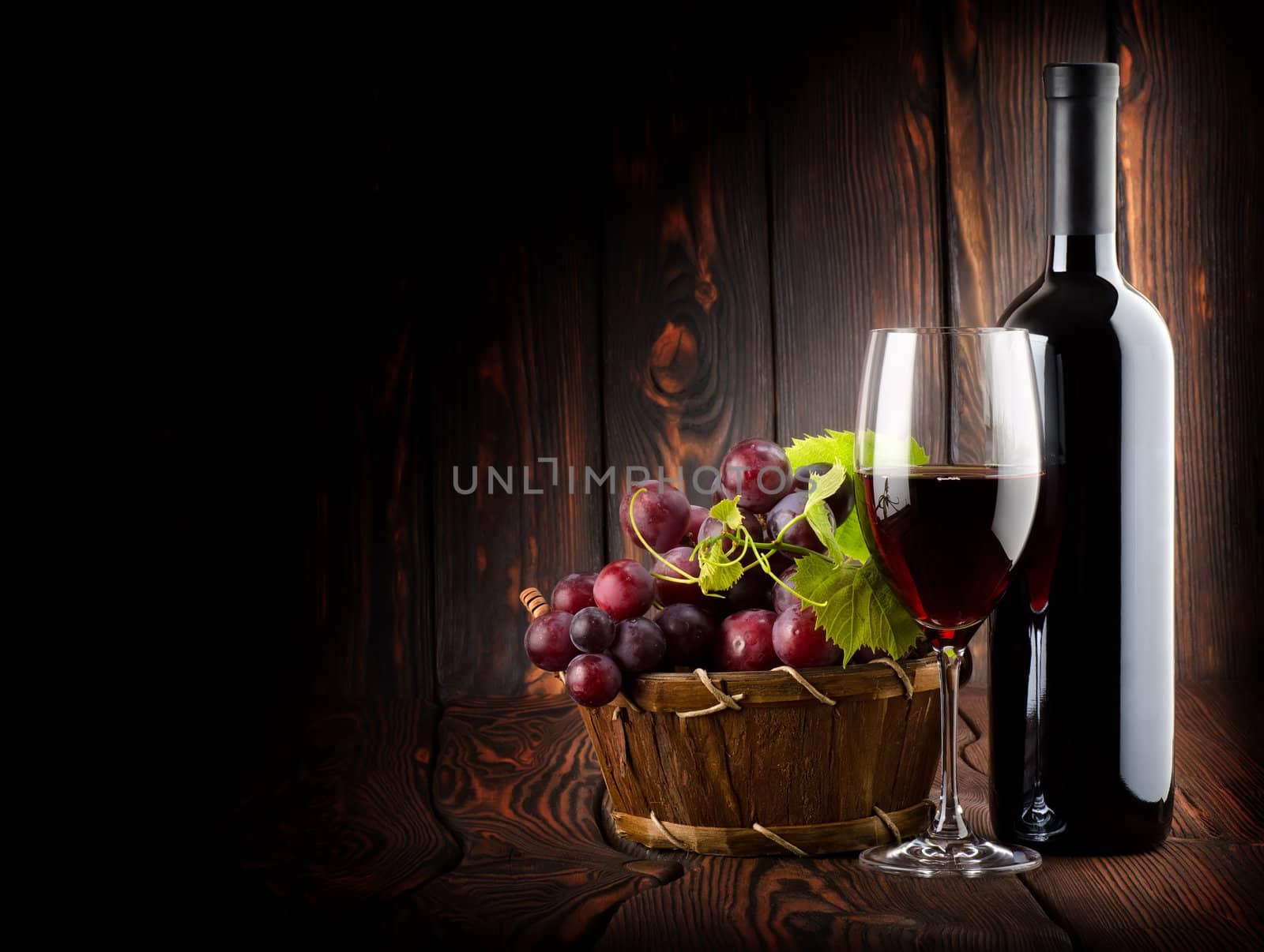 Wine on the dark wooden background by Givaga