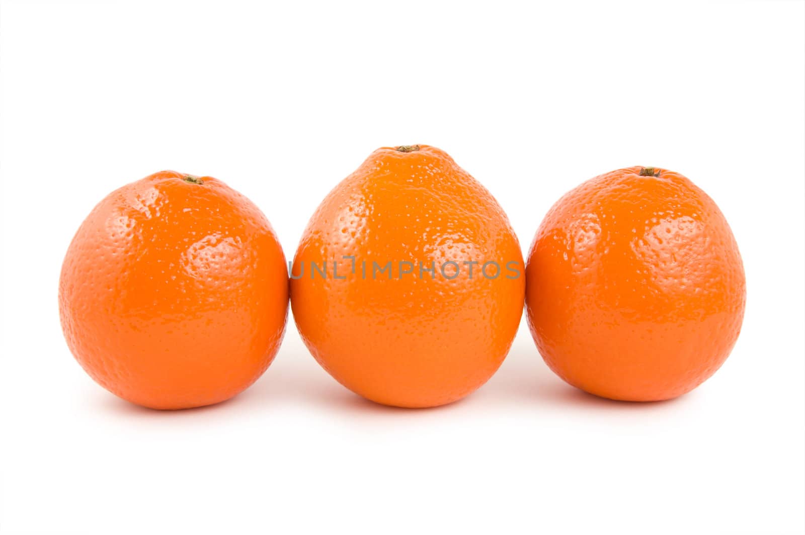 Three perfectly fresh oranges isolated on white