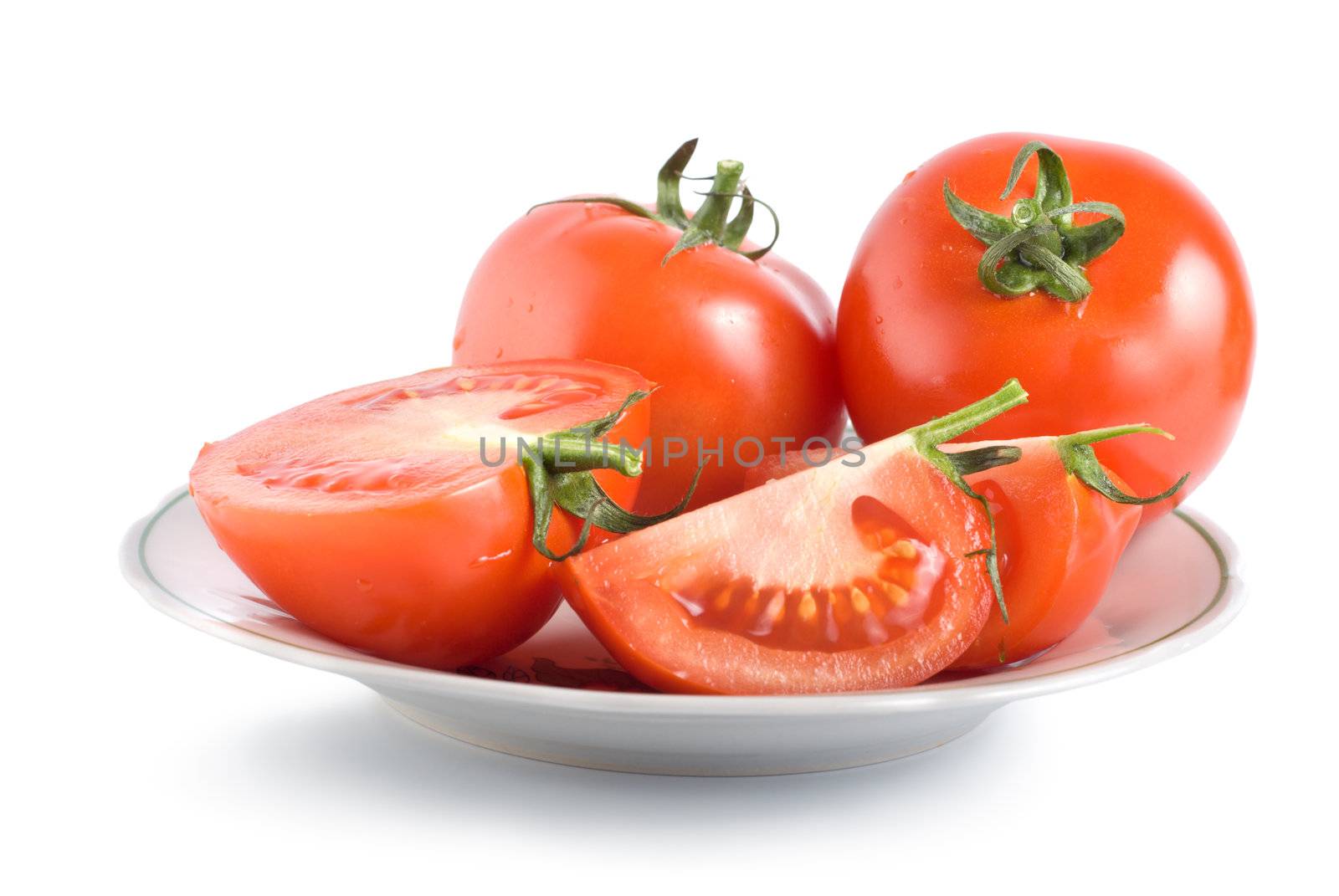 Tomatoes on a plate isolated on white background