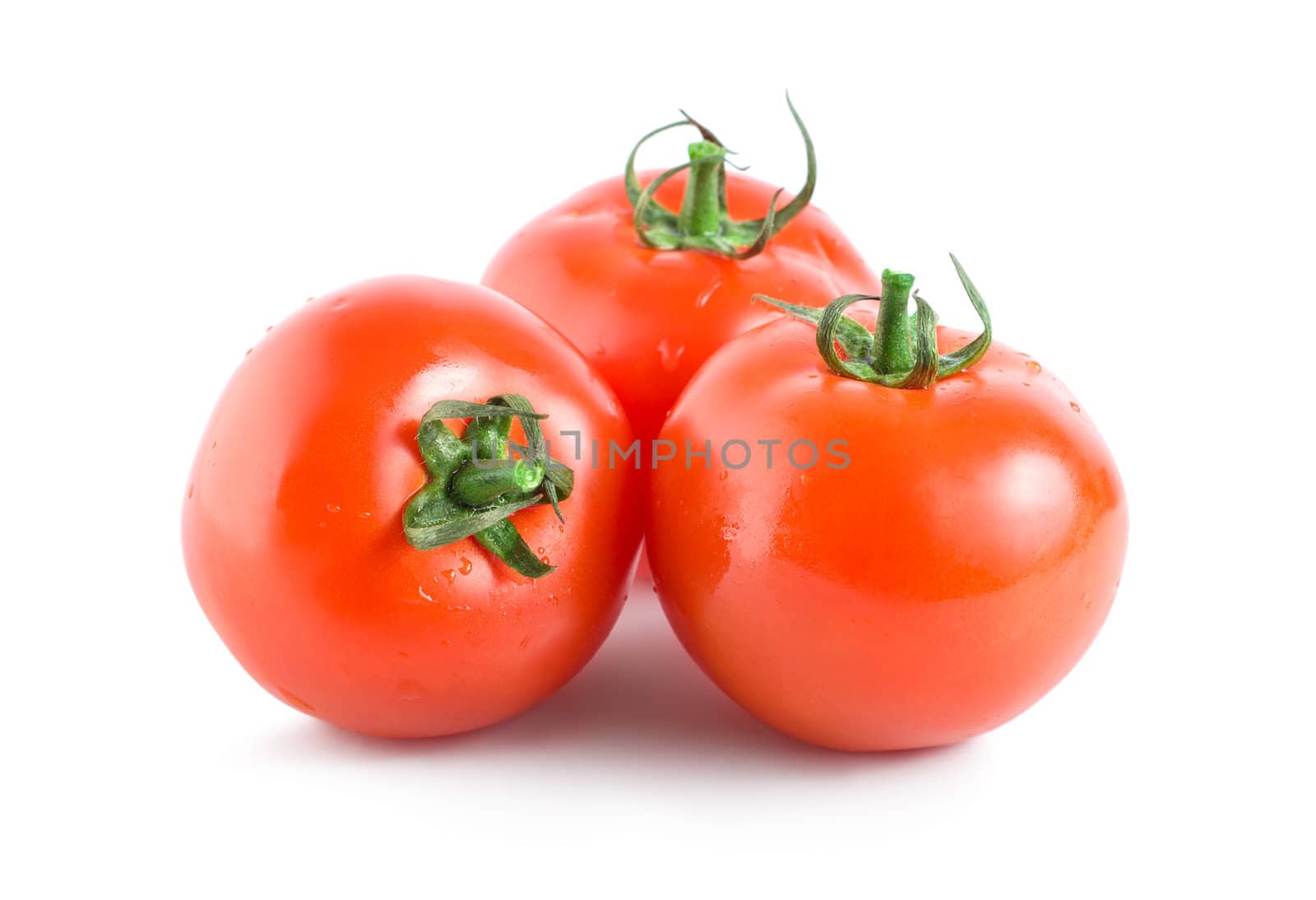 Three red tomatoes isolated on white background