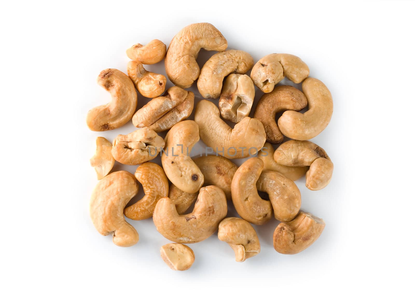 Pile of roasted cashew nuts in isolated white background