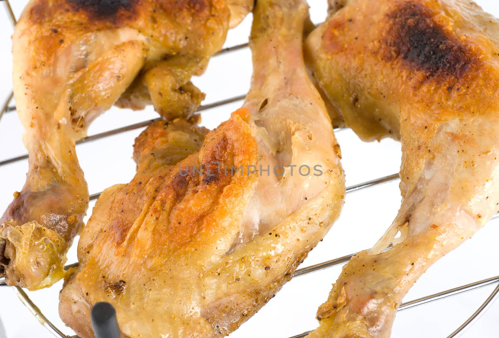 Grilled chicken legs on a white background