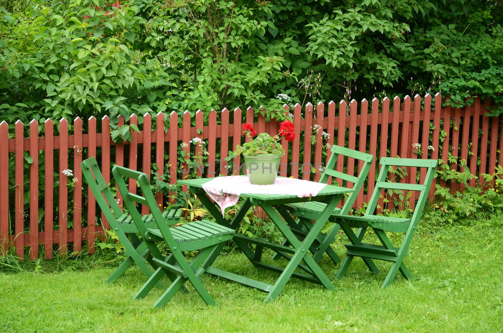 Green garden furniture in olden style made of wood