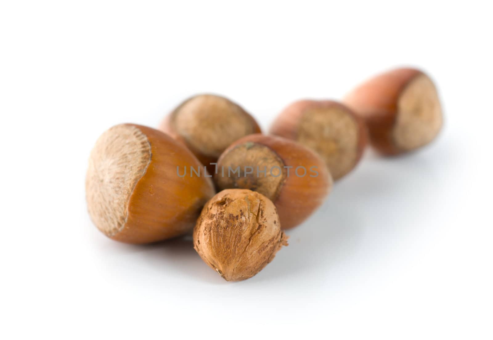 Heap of hazelnuts isolated on a white background