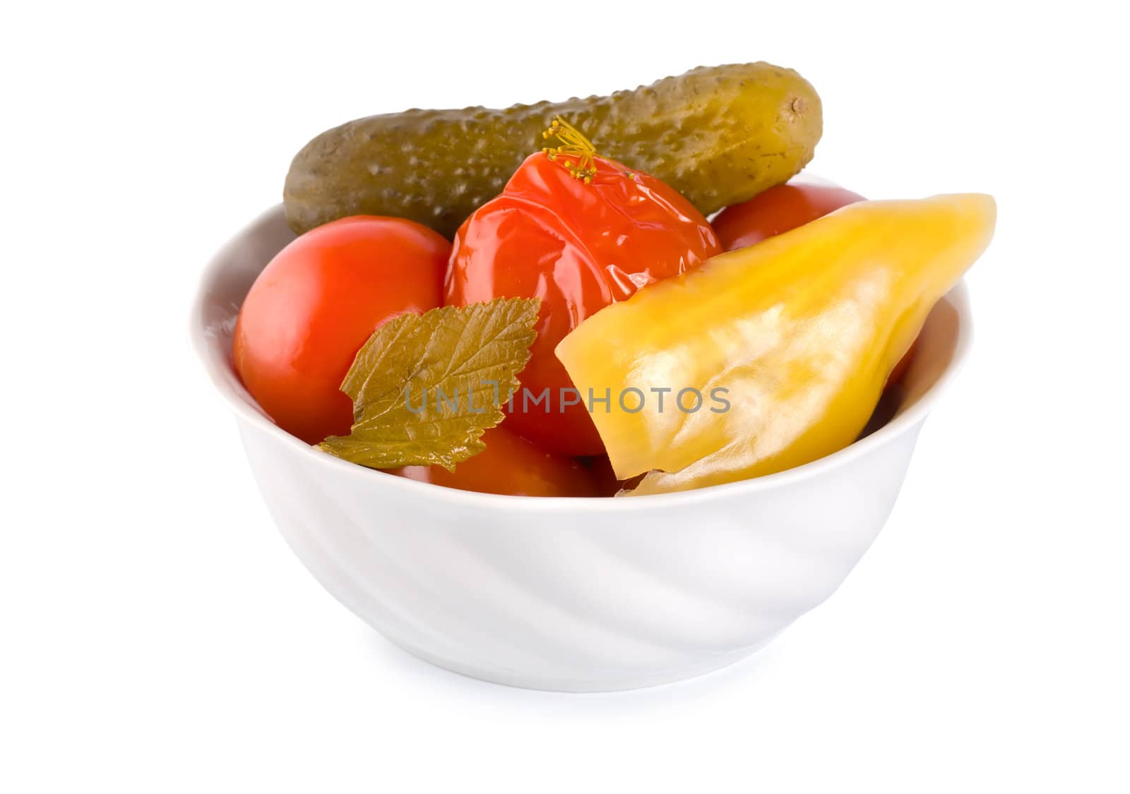 Pickled red tomatoes on a plate isolated on white background
