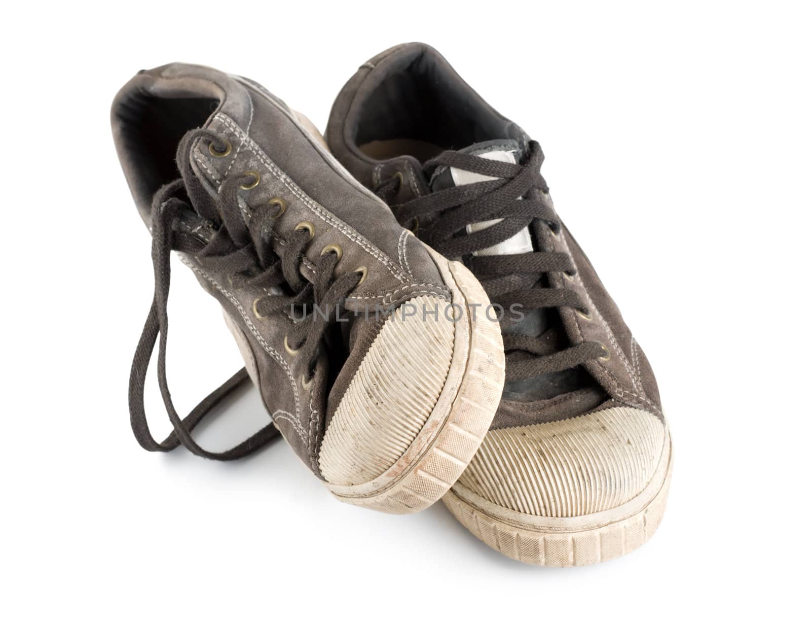 Old dirty sneakers isolated on white background