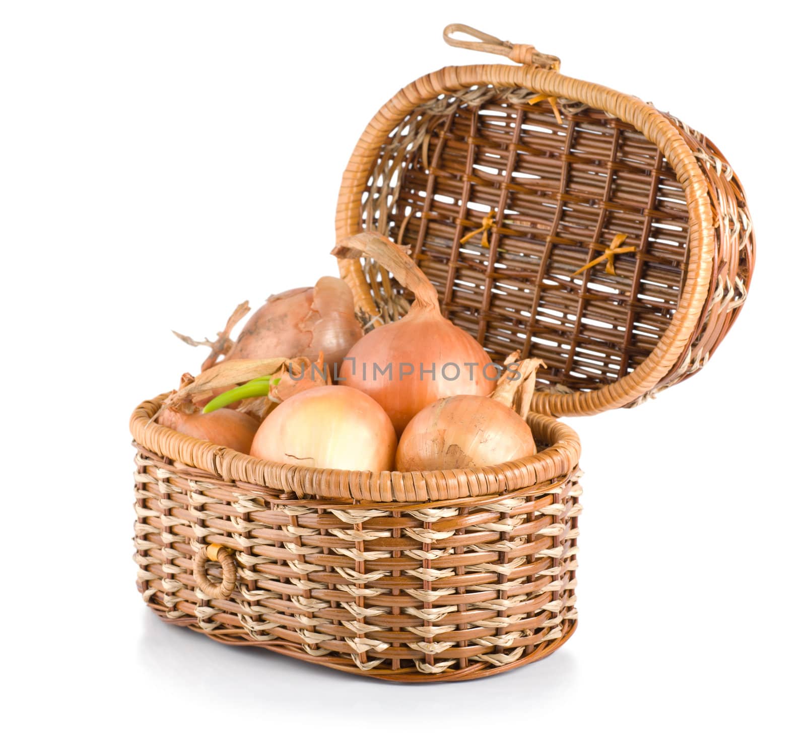 Raw onion in a wooden basket isolated on a white background