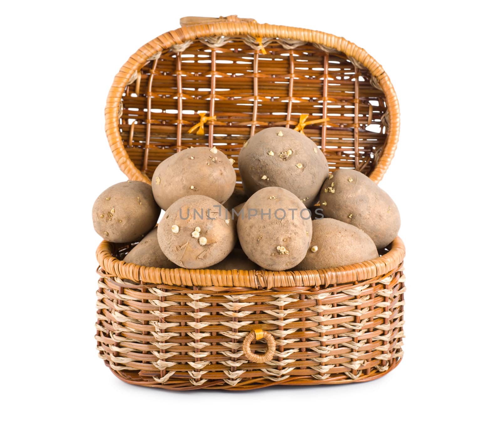 Raw potatoes in a basket isolated on white background