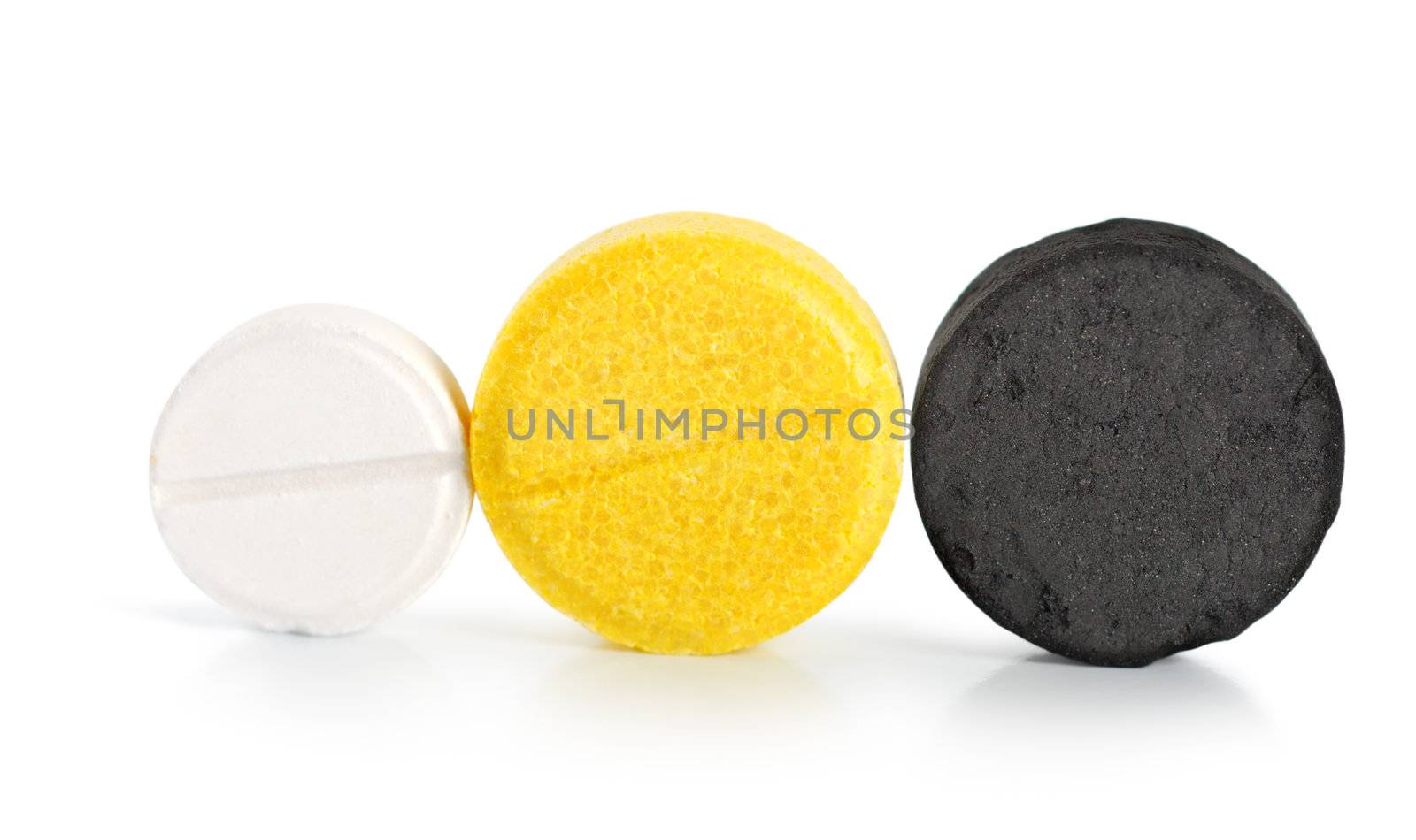 Aspirin, vitamin, coal. Pills isolated on white background