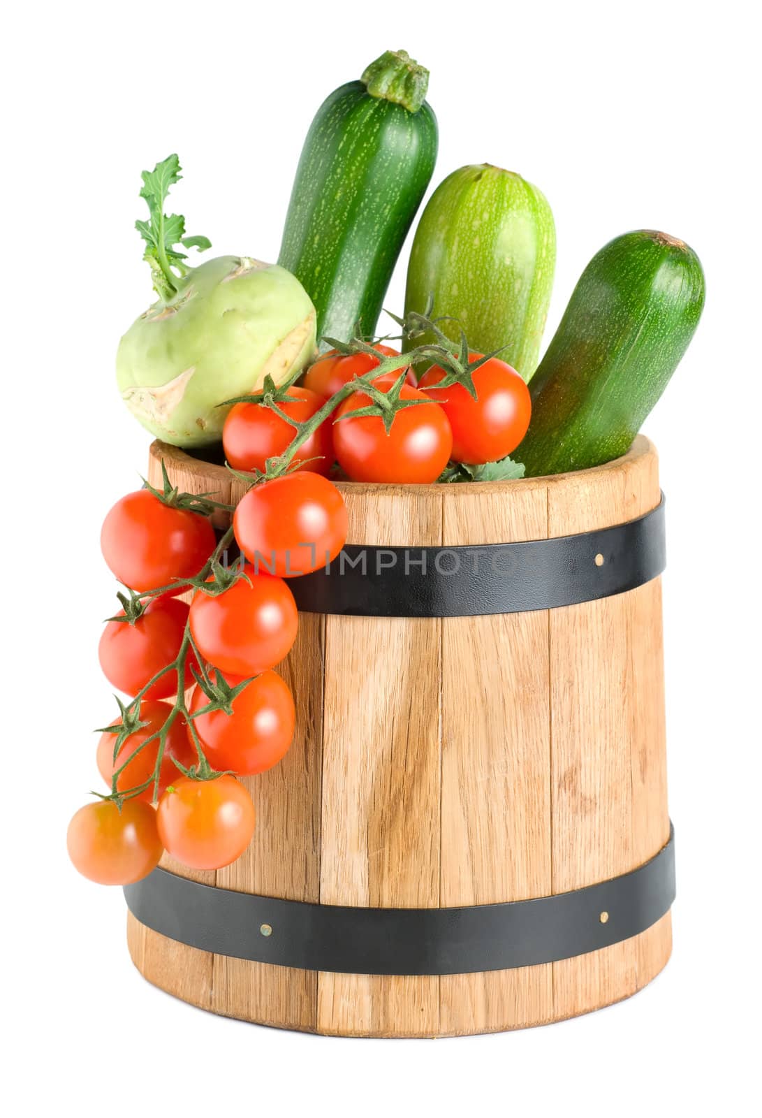 Wooden barrel with vegetables isolated on a white background