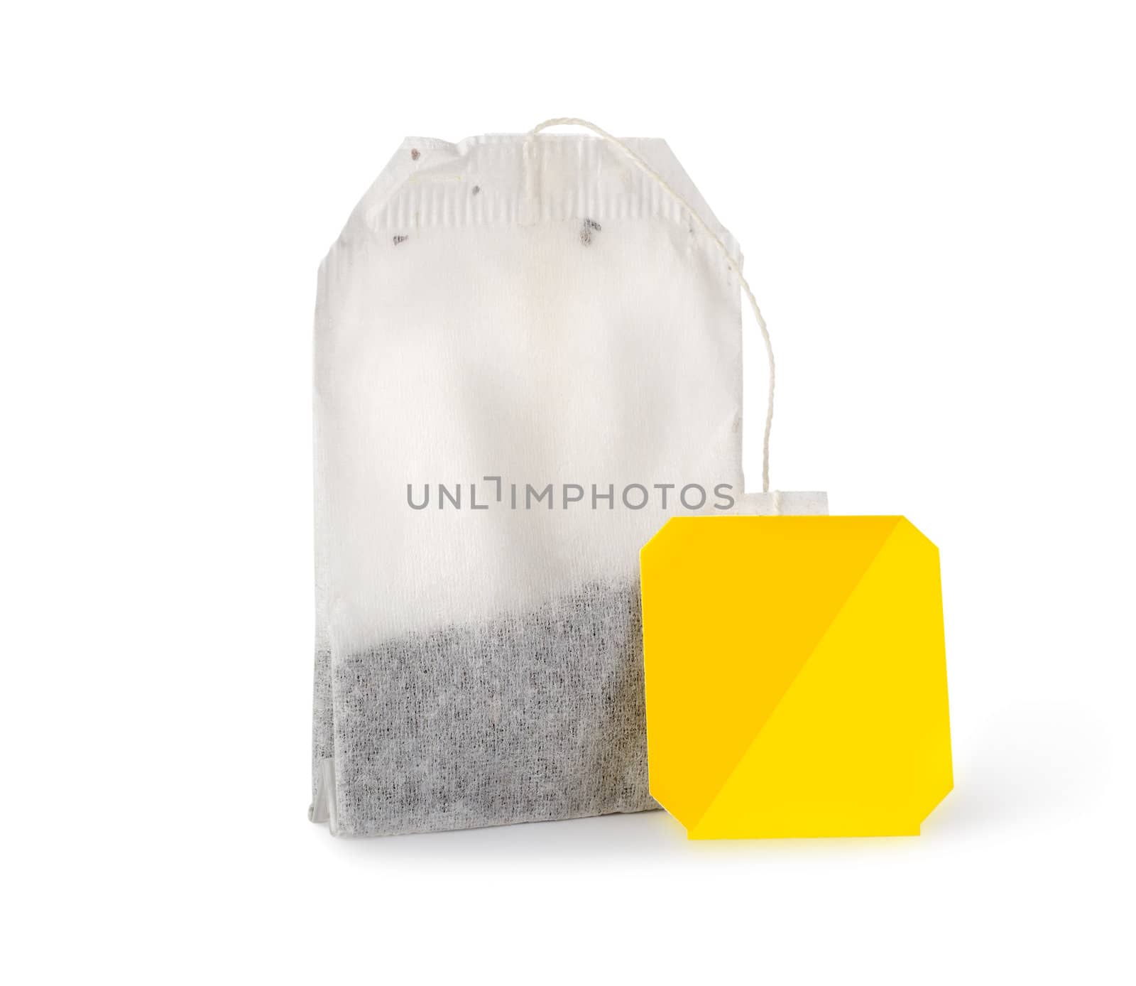 Single tea bag of black tea with yellow label isolated on a white background. Clipping path