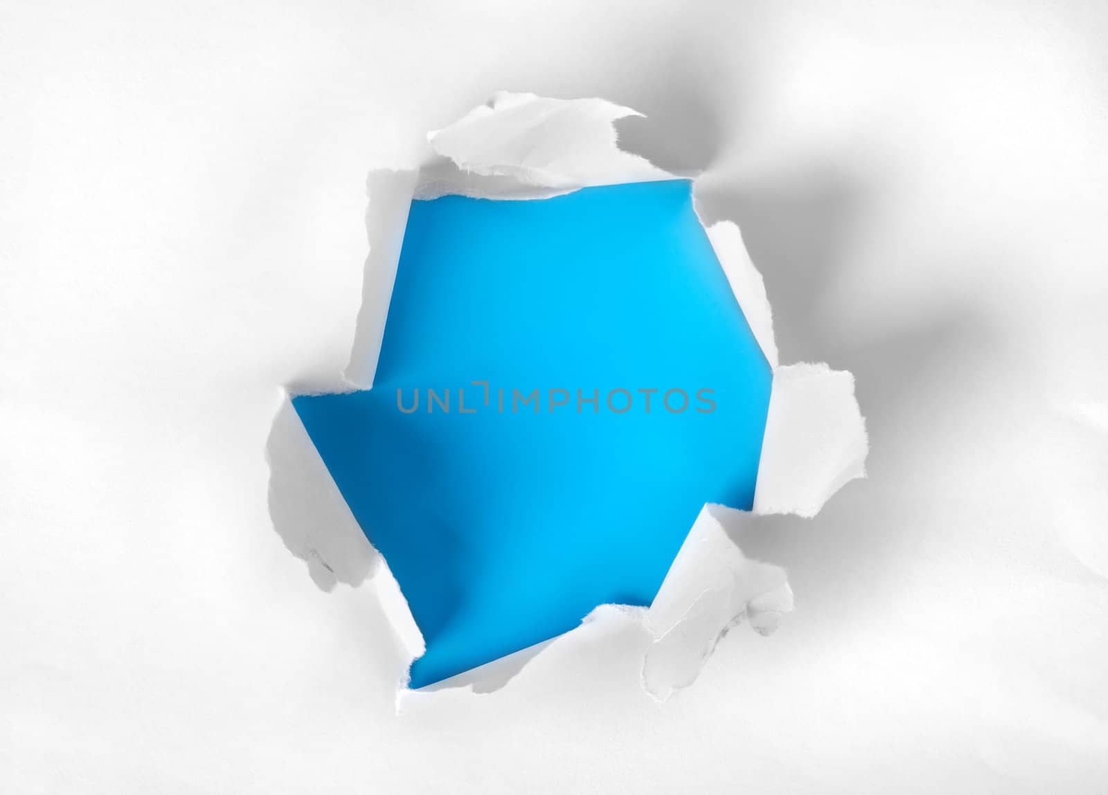 White paper torn with blue background
