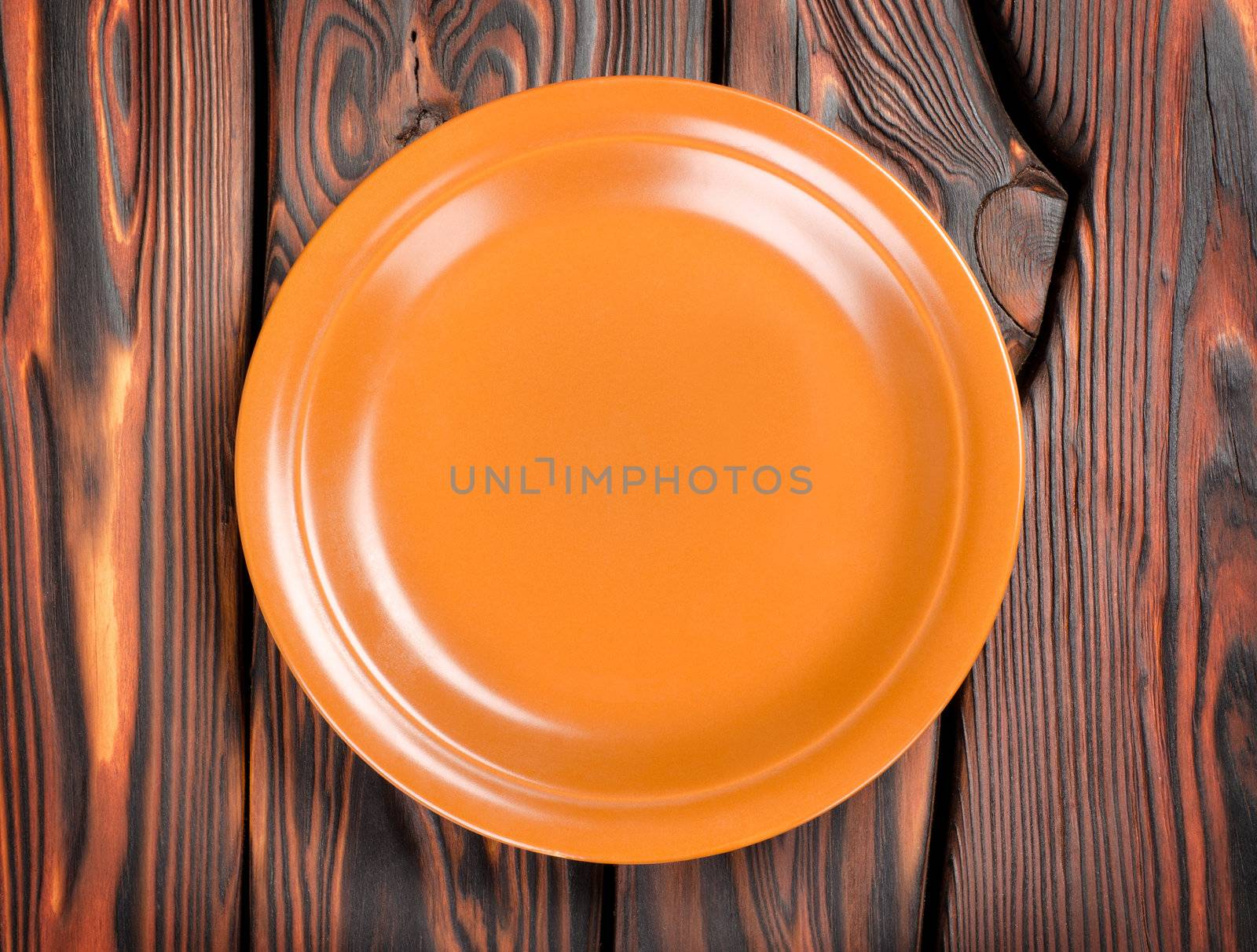 Empty brown plate on a wooden table