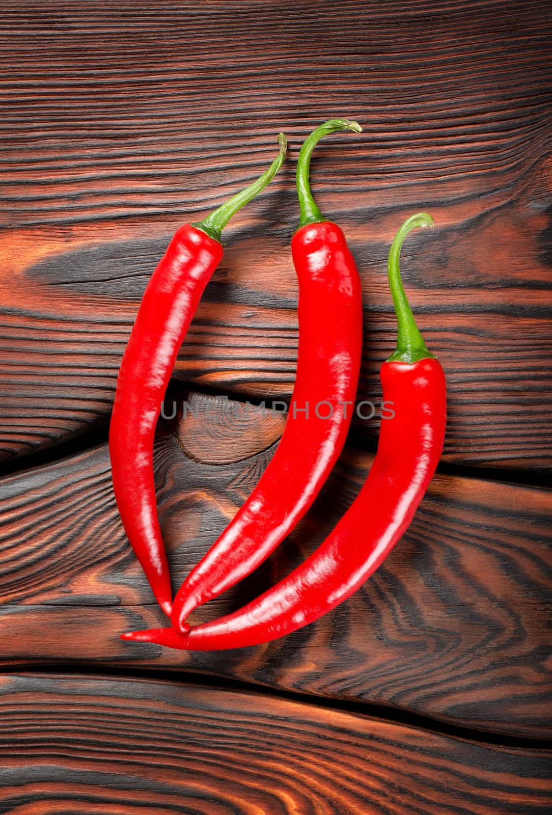 Three red chili peppers by Givaga