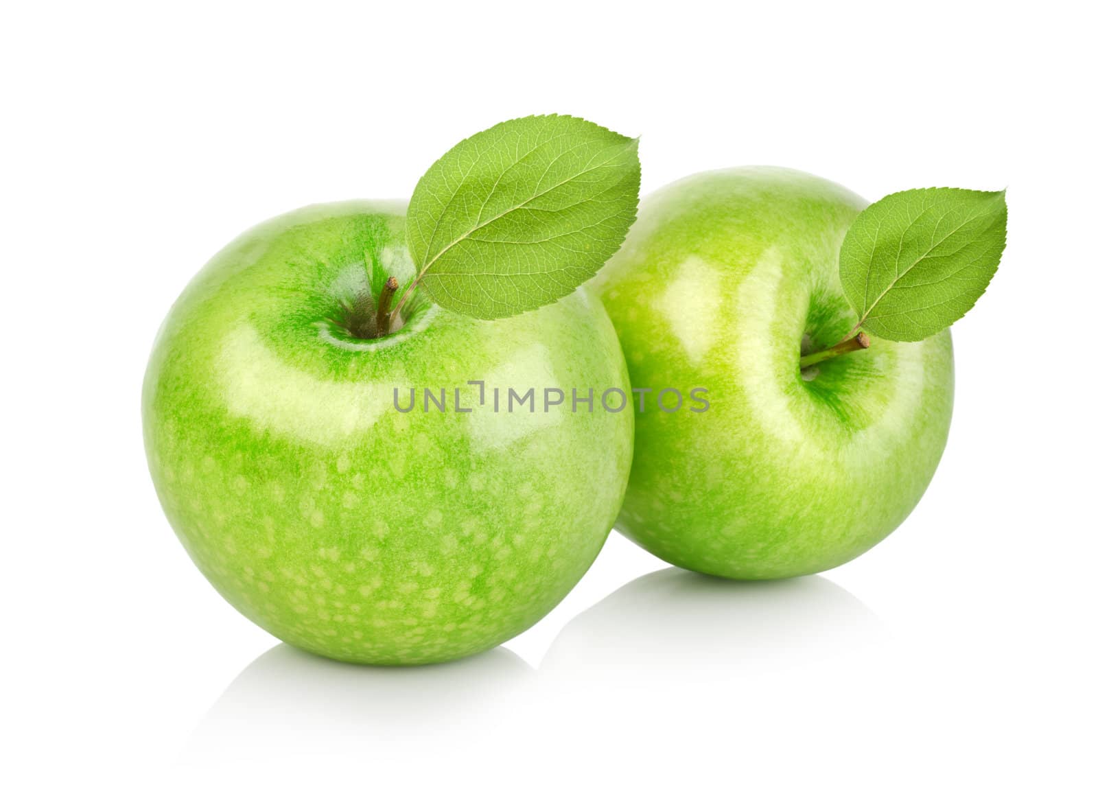 Two green apples with leaves isolated on a white background