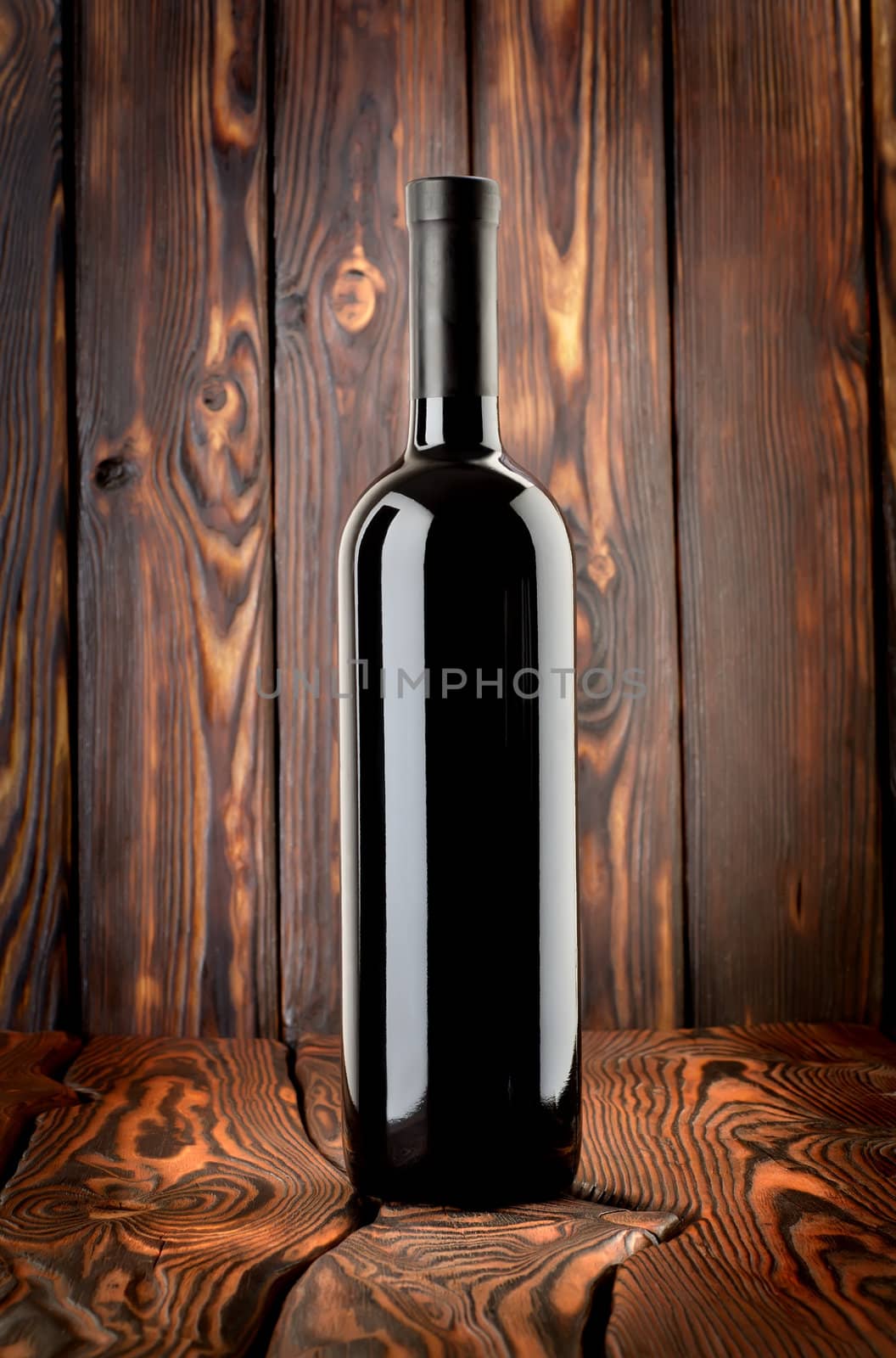 Bottle of red wine on the table by Givaga