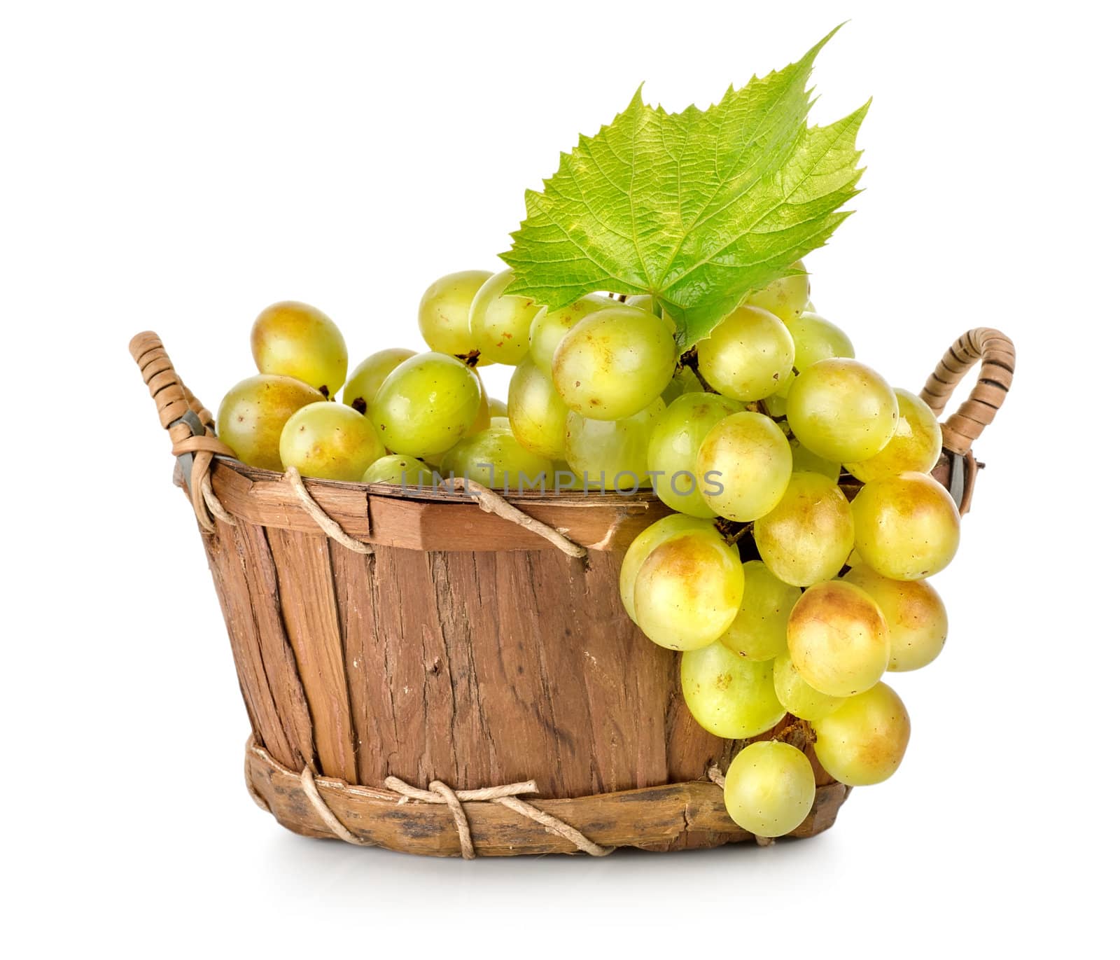 Grapes in a wooden basket isolated by Givaga