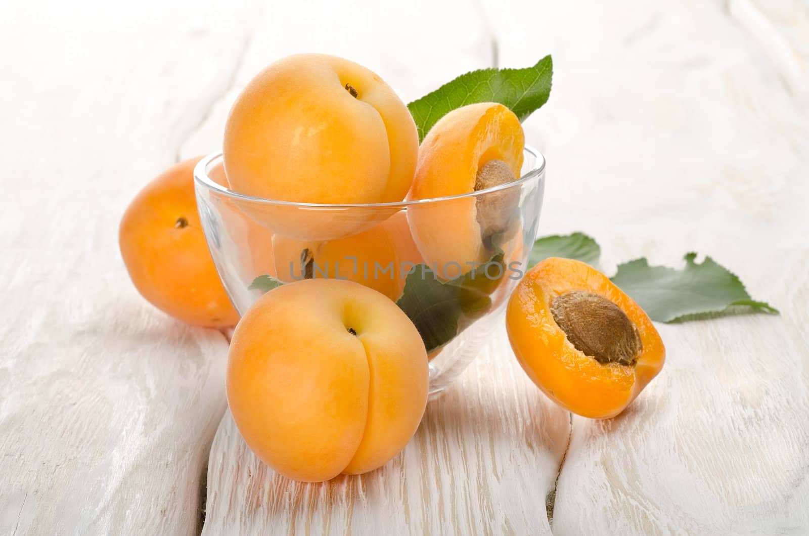 Apricots on a wooden background by Givaga
