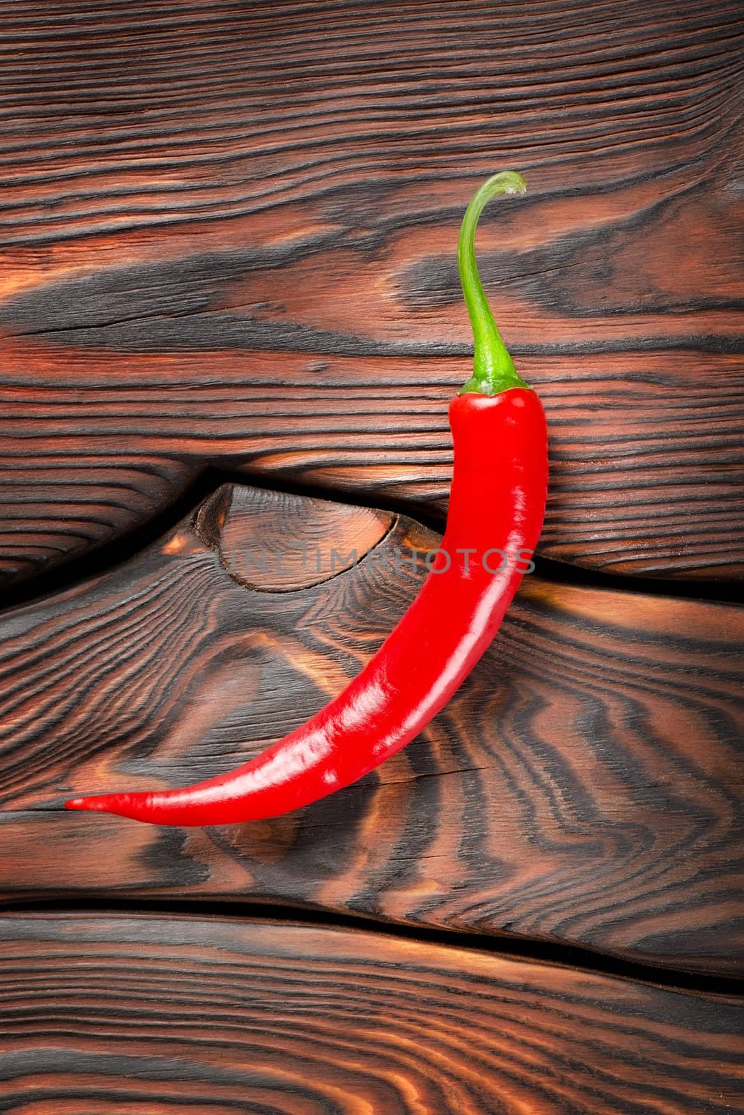 Red chili pepper on a wooden background