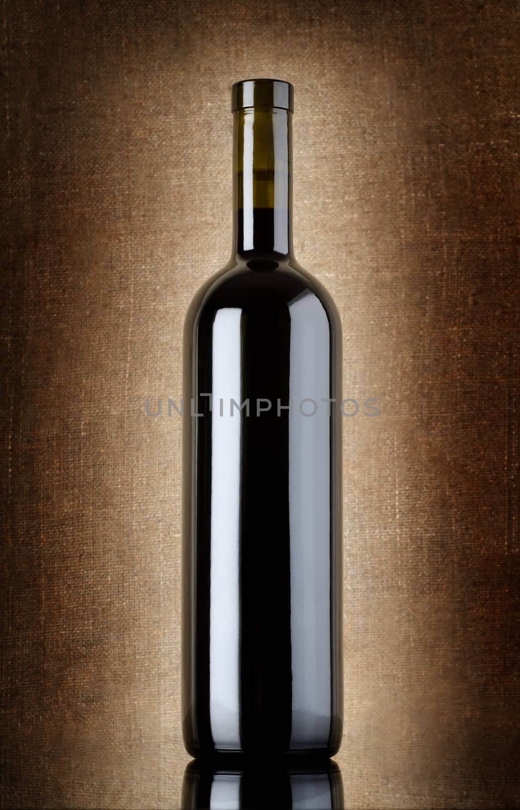 Wine bottle on a background of old canvas