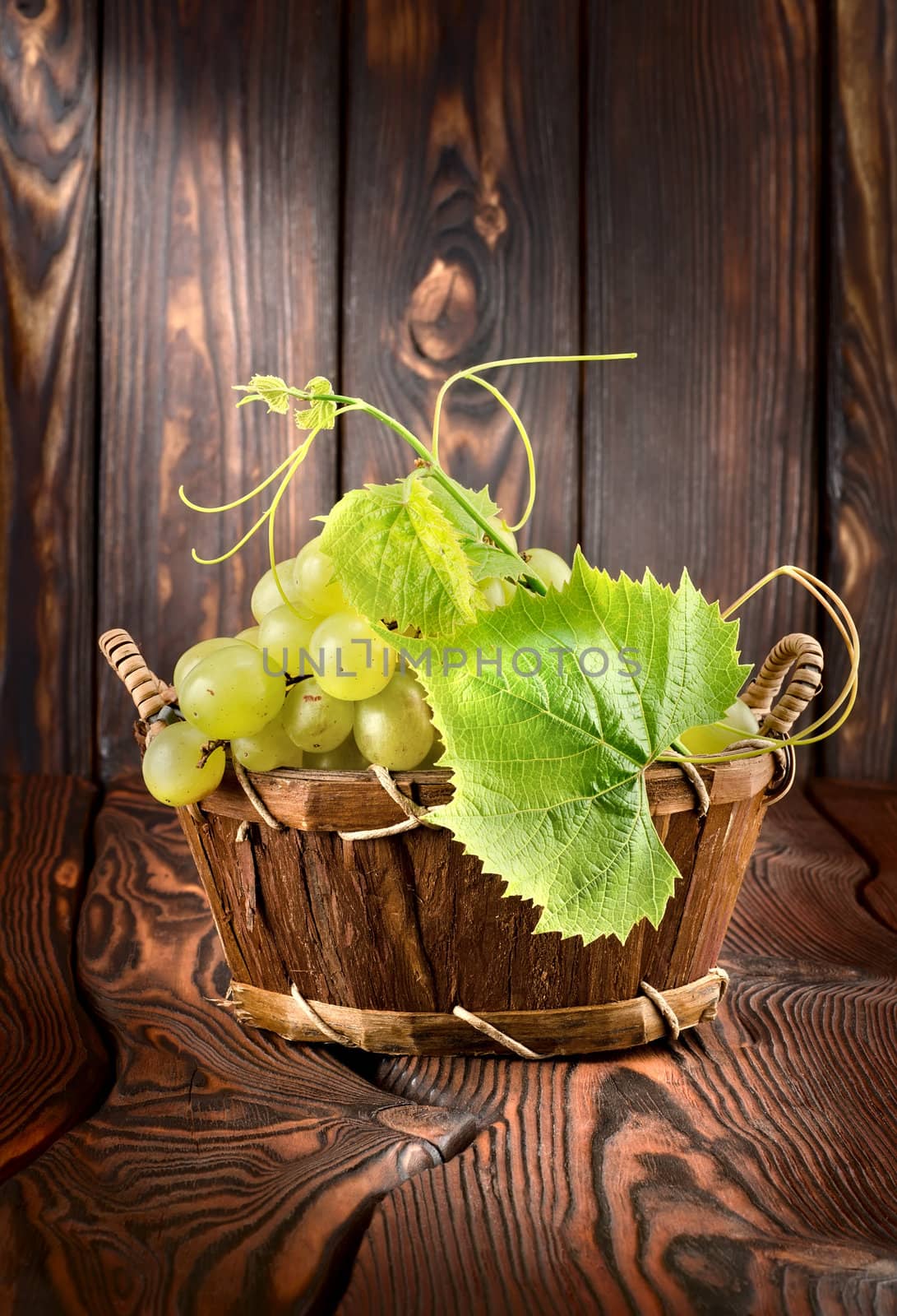 Grapes on a wooden background by Givaga