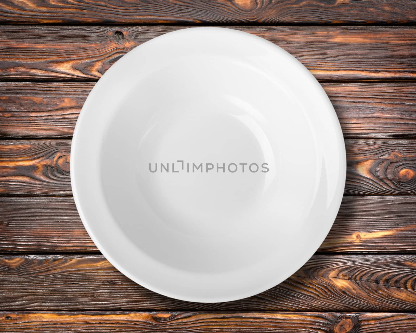 White plate on a brown wooden table