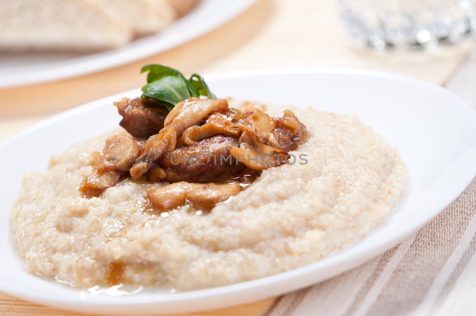 Porridge with fried mushrooms and meat.