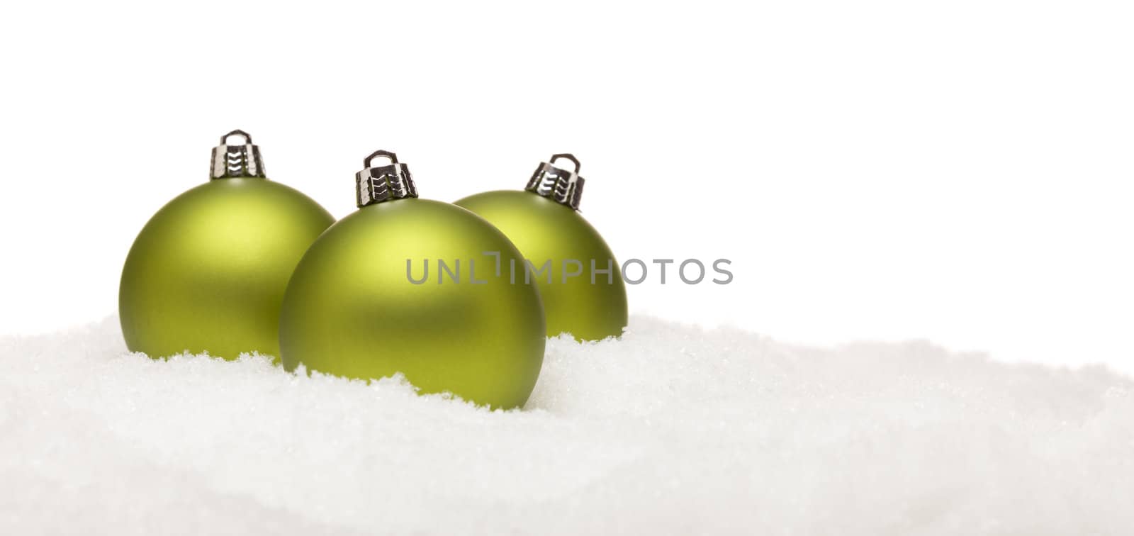 Green Christmas Ornaments on Snow Flakes Isolated on White by Feverpitched