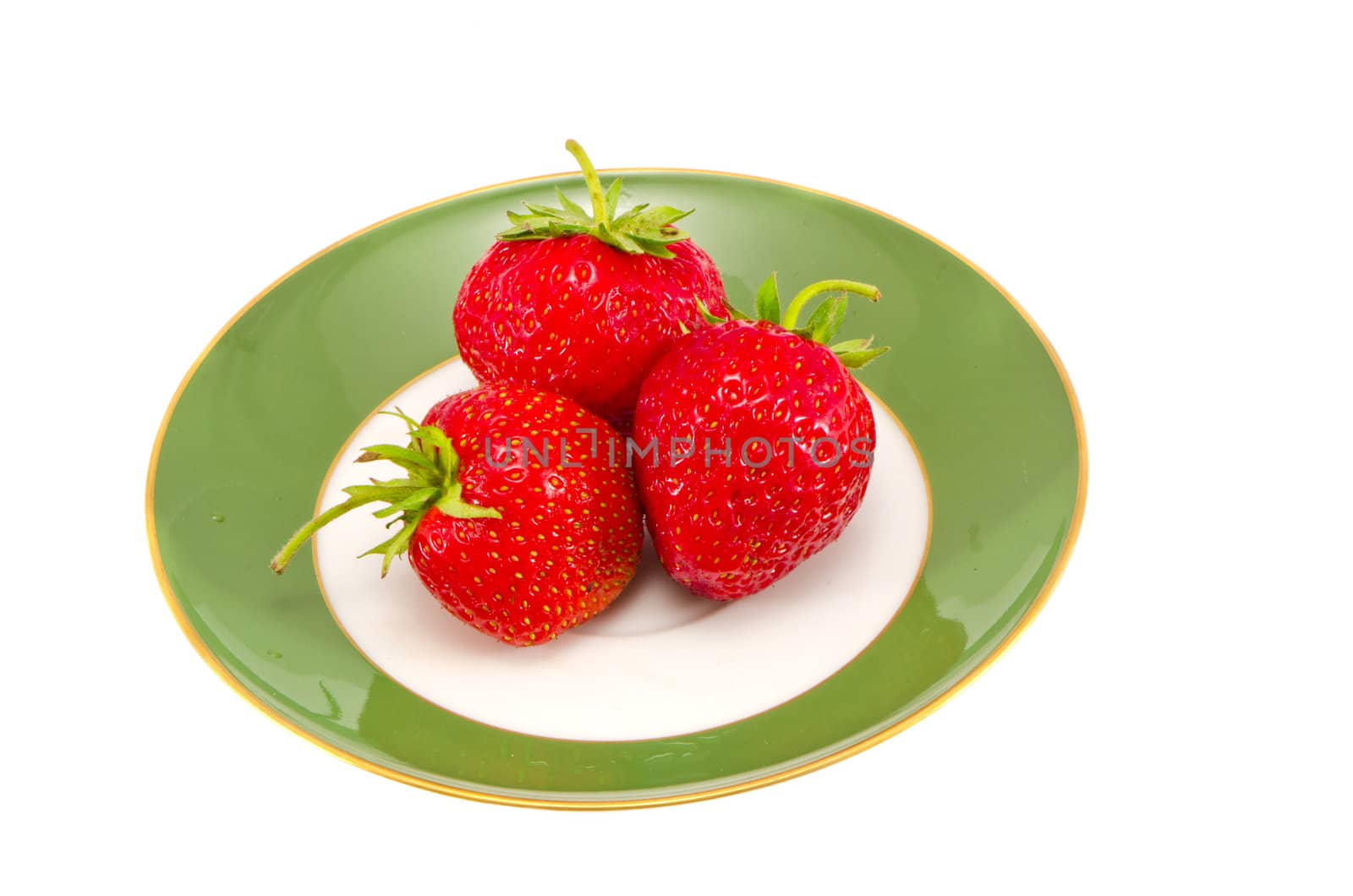 strawberries on the green plate isolated on white