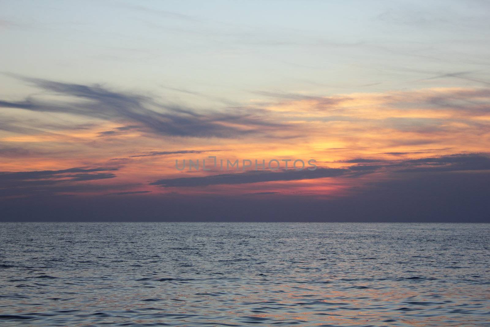 Sun down in the calm sea.