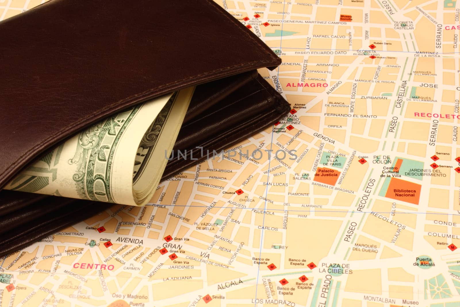 Wallet with banknotes on city map.