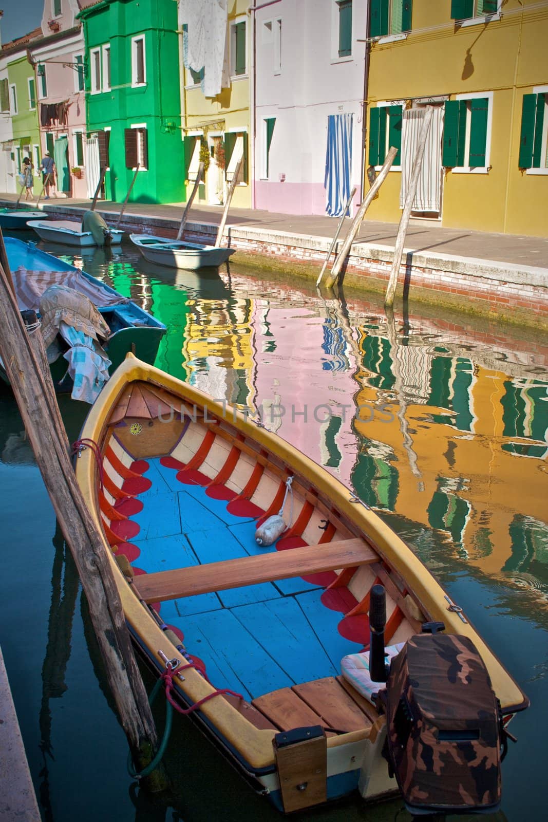 Colorful boat docked in channel