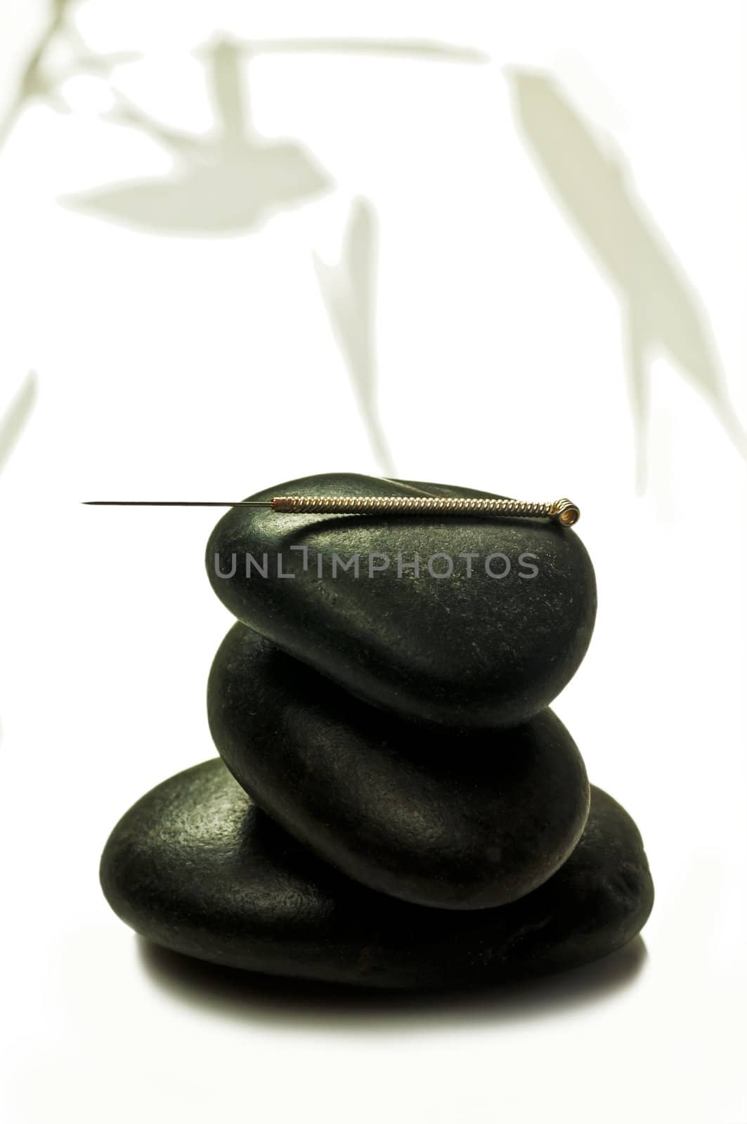 acupuncture needle on stone by Jochen