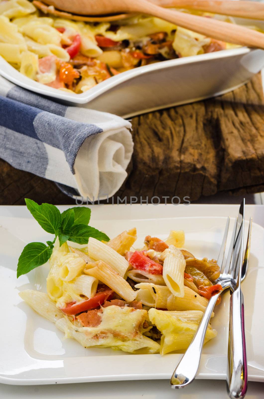 fresh baked Rigatoni casserole with cheese sausage, bacon, tomatoes, cream and herbs