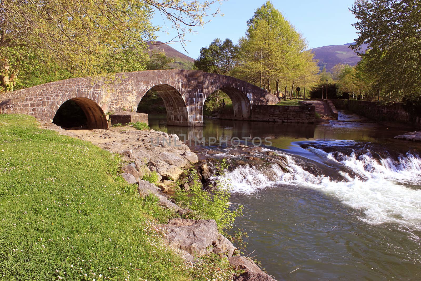 panoramic photo of a waterfalls river under a bridge